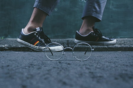 selective focus photography of eyeglasses on road thumbnail