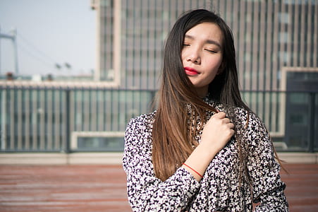 woman standing while black blouse thumbnail