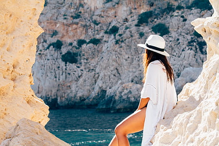 shallow focus photography of a woman wearing white sun hat thumbnail