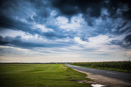 road under dark sky at daytime thumbnail