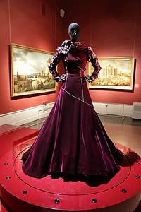 mannequin wearing burgundy velvet gown on display thumbnail