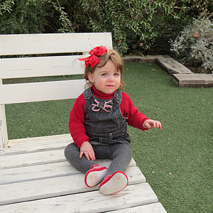girl sitting on white wooden bench thumbnail