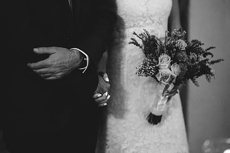 grayscale photography of woman holding bouquet with father escort thumbnail
