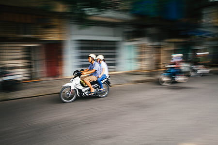 panning photography of men and women riding motorcycle thumbnail