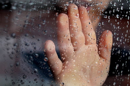 human hand touching glass panel with water moist thumbnail
