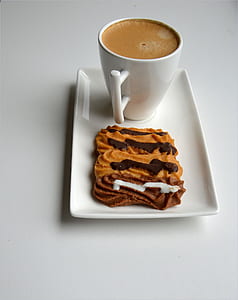 white ceramic mug beside cookie thumbnail