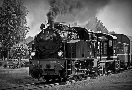 greyscale photo of steam locomotive train thumbnail