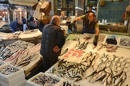 man in black bubble vest standing in fish stall thumbnail