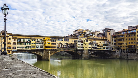 yellow painted bridge under cloudy sky thumbnail