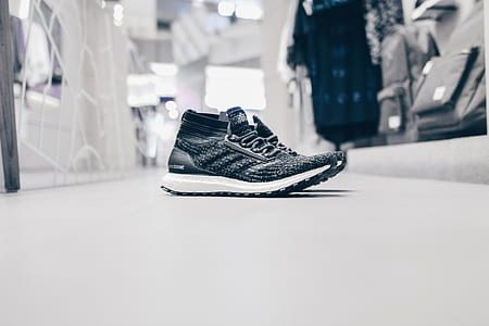 pair of black-and-white sneakers on white surface thumbnail