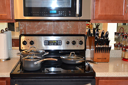 black cooking pots on smooth-top range oven thumbnail