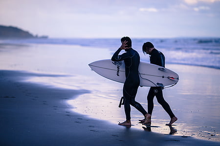 two men walking on seashore thumbnail