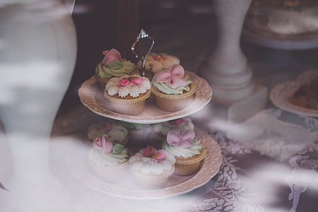 cupcakes on round brown 2-tier rack on brown wooden table thumbnail
