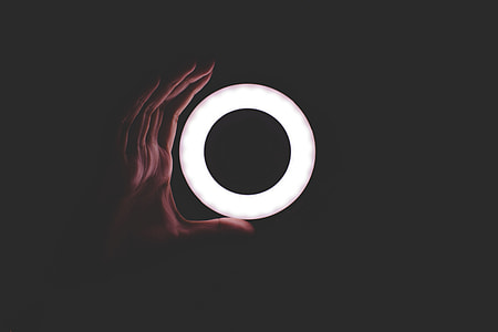 person holding round white neon light thumbnail
