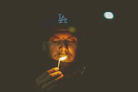 man holding match thumbnail