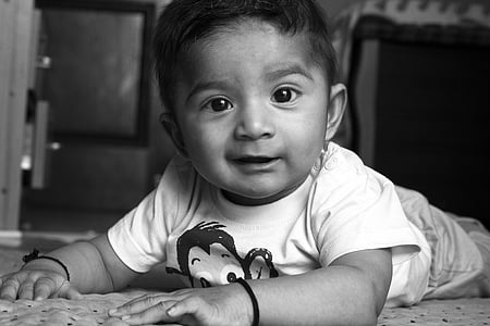 grayscale photo of boy crawling and smiling thumbnail