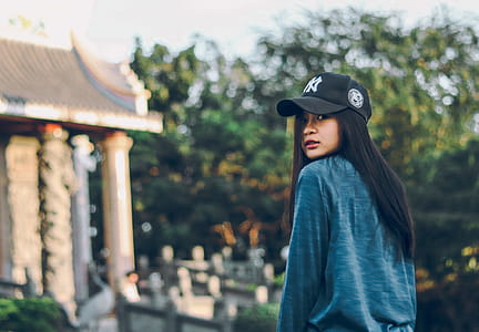 Woman Wearing Sweater And Baseball Cap thumbnail
