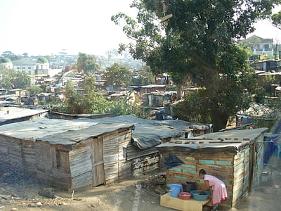 girl washing clothes near houses thumbnail