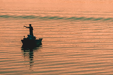 man fishing while riding on boat thumbnail