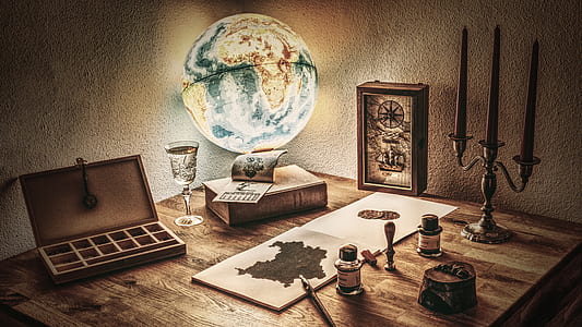 desk globe beside book thumbnail