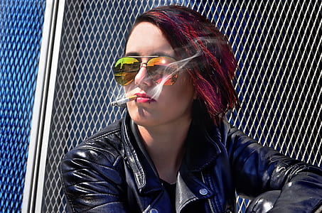 woman wears black leather jacket while smoking thumbnail