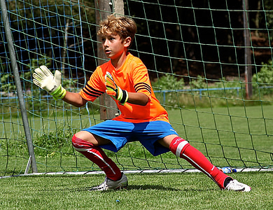 boy about to catch near goal net thumbnail
