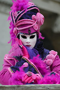 selective focus photograph person in pink and purple outfit and mask thumbnail