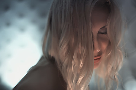 selective focus photography of woman with blonde hair in black top thumbnail