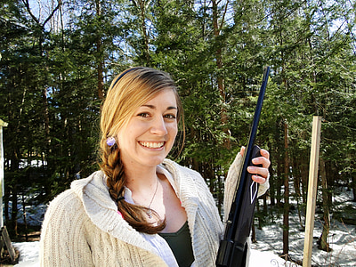 woman holding black rifle thumbnail