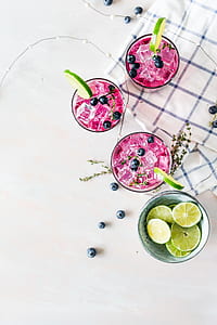 beverage with berries and lime in clear glasses thumbnail