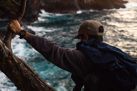 man holding on tree branch thumbnail