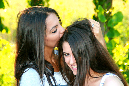 woman wearing white tops kissing head of woman thumbnail
