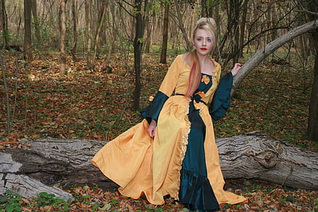 woman sitting on tree log in forest thumbnail