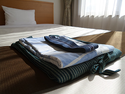 three black-and-blue striped cloth on bed thumbnail