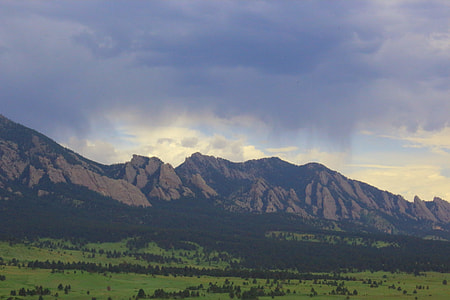 landscape photography of brown mountain surrounded of green leafed trees thumbnail