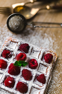Breakfast waffles with fresh raspberries and powdered sugar thumbnail