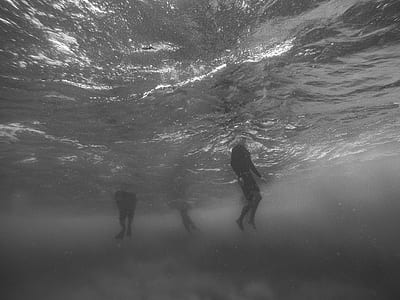 three person on body of water thumbnail