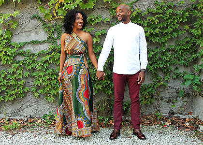 man in white sweater and women in yellow and green one-shoulder dress thumbnail