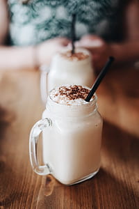 clear glass jar mug with ice cream on brown wooden table thumbnail