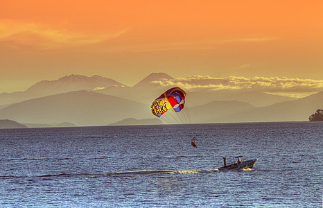 person parasailing during dusk thumbnail
