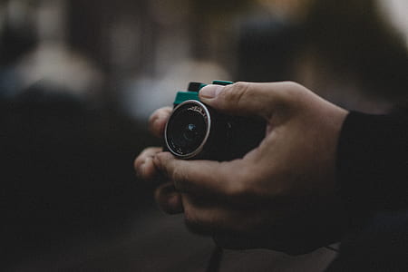 person holding black DSLR camera thumbnail