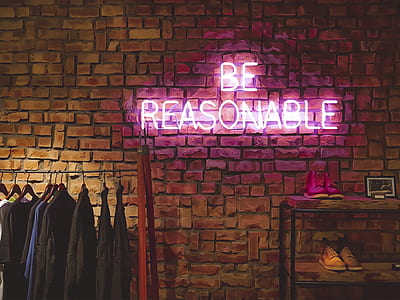 purple be reasonable neon signage hanged on brown brick wall thumbnail