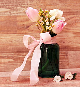 white flowers in green glass vase with pink ribbon thumbnail