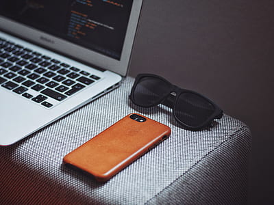 black framed sunglasses near iPhone thumbnail