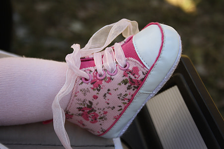 toddler wearing pink and white floral lace-up sneaker in close-up photo thumbnail