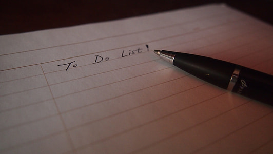black retractable pen on black lined paper thumbnail