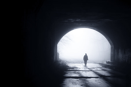 silhouette of man walking from tunnel thumbnail