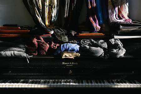 assorted-color textiles on black piano thumbnail