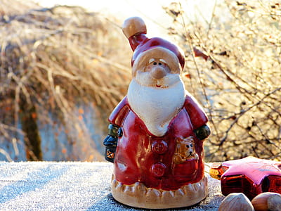 brown and red Santa Claus figurine near star ornament thumbnail