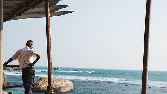 man standing near sea at daytime thumbnail